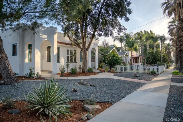 a view of a house with a tree in front