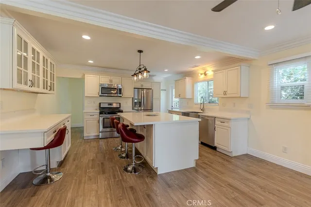 a kitchen with a stove a sink a dining table and chairs