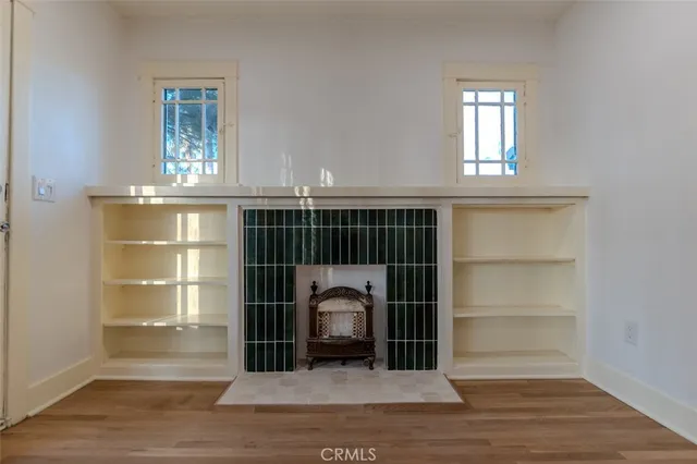 a view of a livingroom with wooden floor and a window