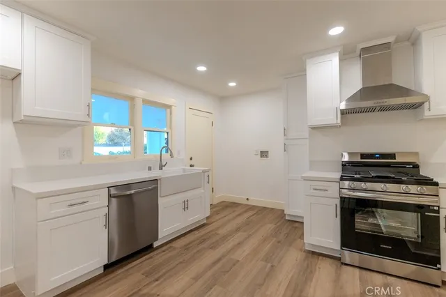 a kitchen with stainless steel appliances a stove a sink and a refrigerator