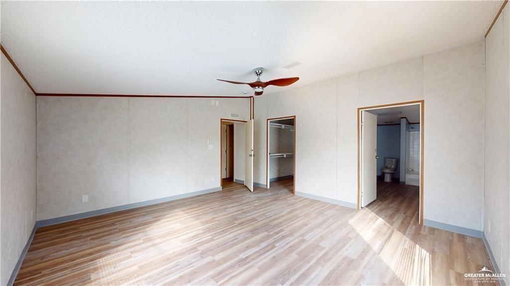 613 East Loop 19th Street Weslaco, TX 78596 - Photo 11 of 30 a view of a room with wooden floor and ceiling fan