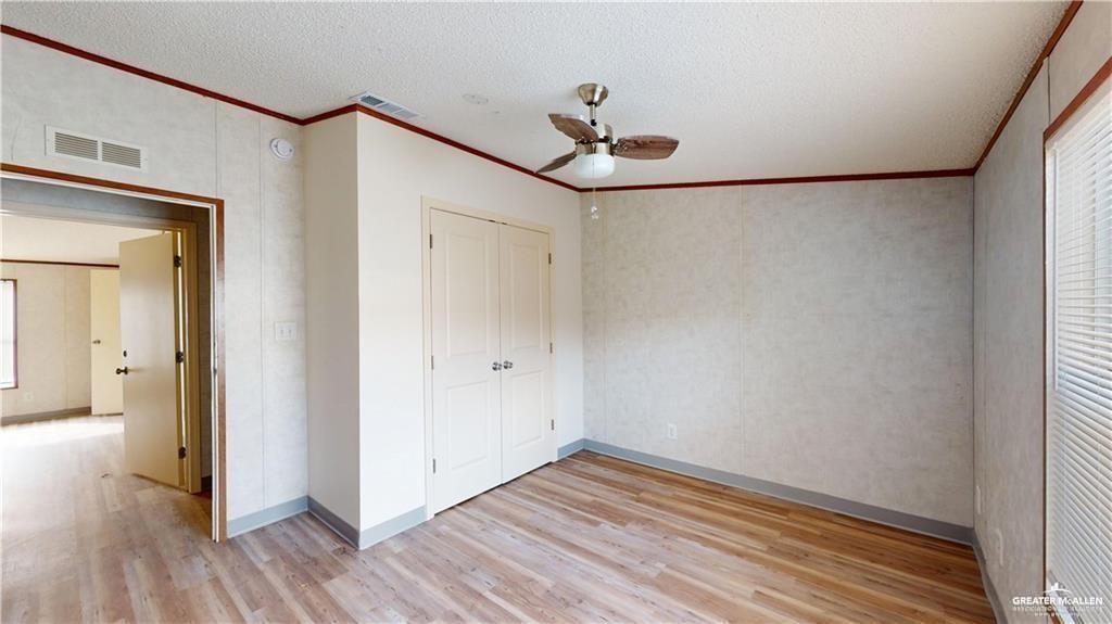 613 East Loop 19th Street Weslaco, TX 78596 - Photo 16 of 30 a view of an empty room with wooden floor and a window