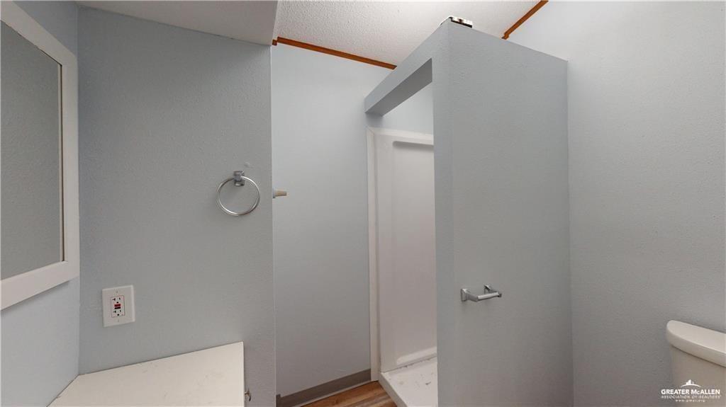 613 East Loop 19th Street Weslaco, TX 78596 - Photo 23 of 30 a bathroom with a toilet and a shower
