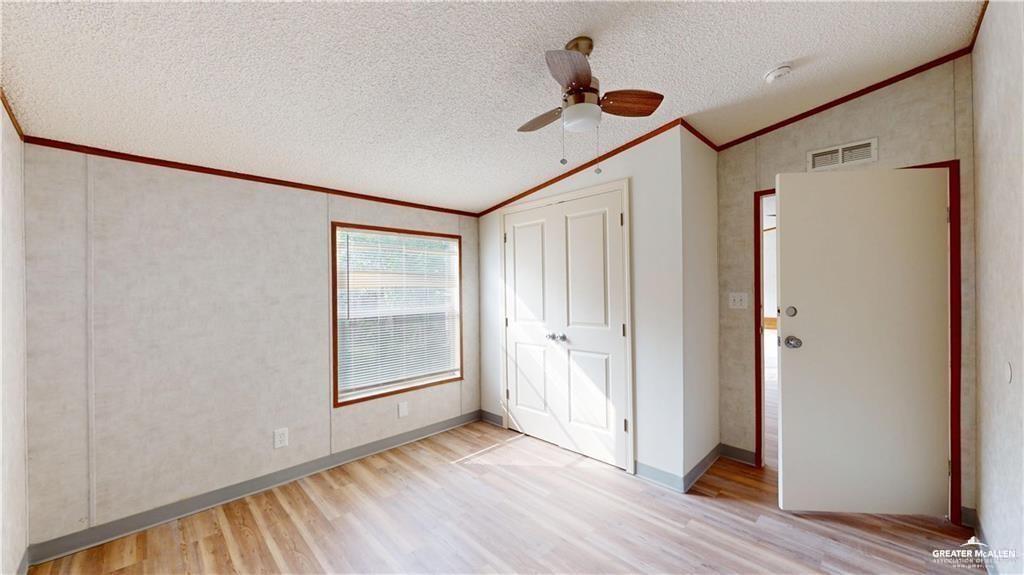 613 East Loop 19th Street Weslaco, TX 78596 - Photo 24 of 30 a view of an empty room with wooden floor and a window