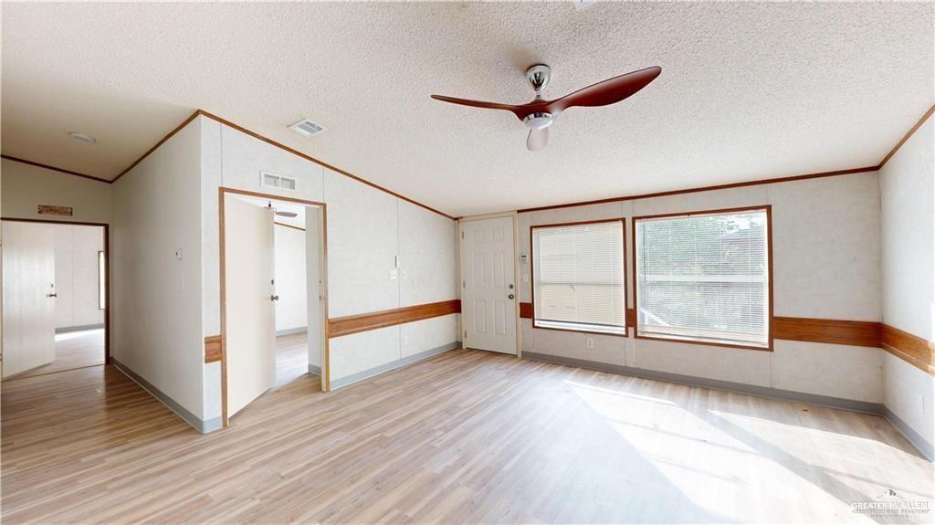613 East Loop 19th Street Weslaco, TX 78596 - Photo 26 of 30 a view of an empty room with a window and wooden floor