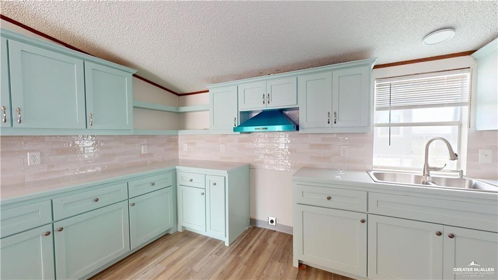 613 East Loop 19th Street Weslaco, TX 78596 - Photo 6 of 30 a kitchen with white cabinets sink and stove