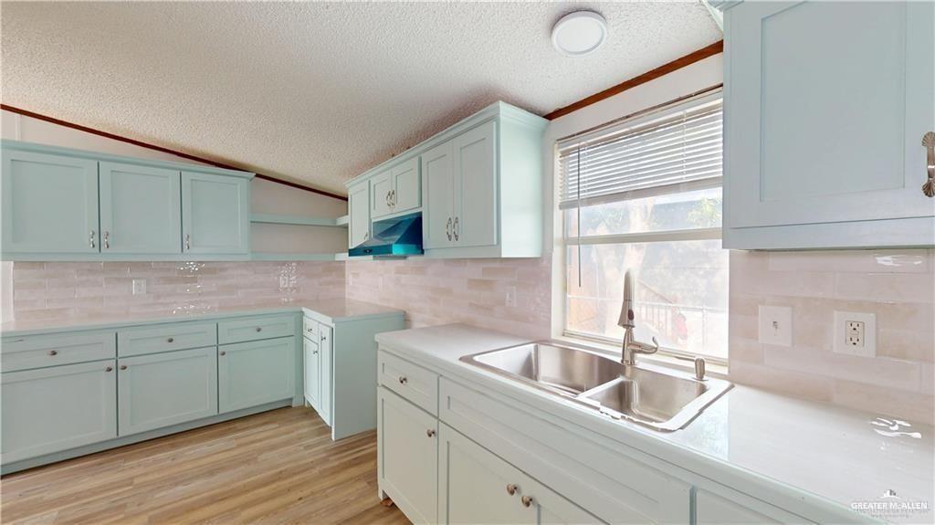 613 East Loop 19th Street Weslaco, TX 78596 - Photo 10 of 30 a kitchen with a sink cabinets and window