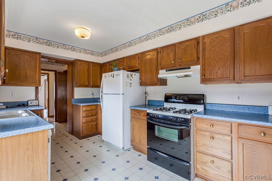 8338 Marye Road Partlow, VA 22534 - Photo 12 of 32 a kitchen with a stove top oven and refrigerator