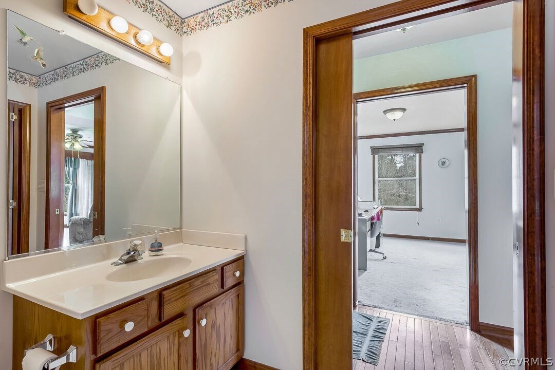8338 Marye Road Partlow, VA 22534 - Photo 15 of 32 a bathroom with a sink a mirror and a vanity
