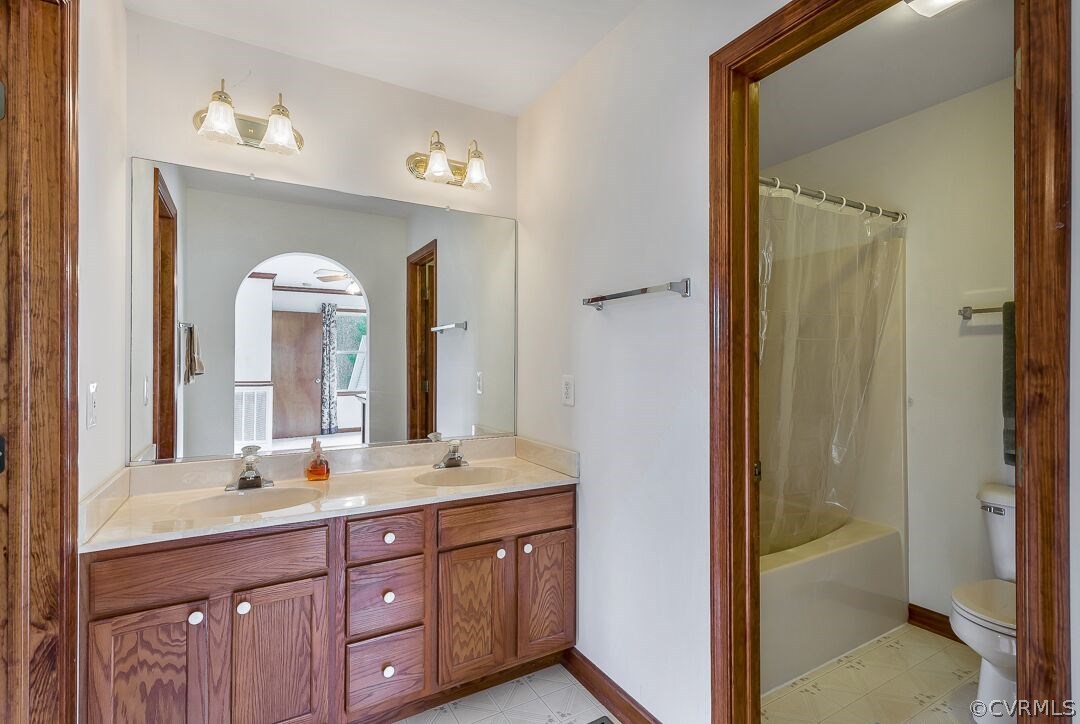 8338 Marye Road Partlow, VA 22534 - Photo 18 of 32 a bathroom with a double vanity sink and a mirror