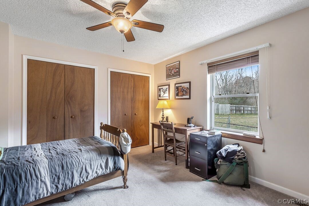 8338 Marye Road Partlow, VA 22534 - Photo 19 of 32 a spacious bedroom with a bed and a chandelier