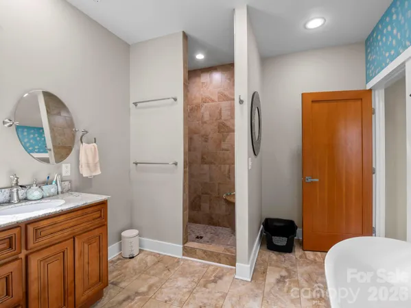 a spacious bathroom with a double vanity sink a toilet and shower