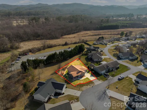 an aerial view of house with backyard