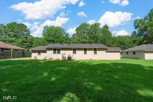 a front view of a house with a yard porch and green space