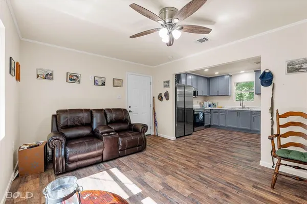 a living room with furniture and kitchen view