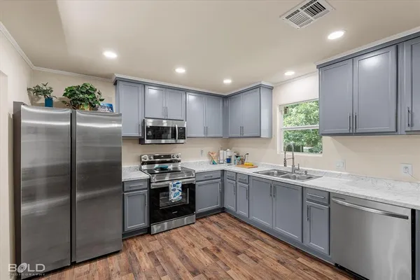 a kitchen with a sink stainless steel appliances and cabinets