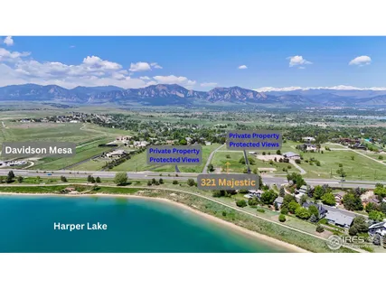 a open area with green field and trees in the background