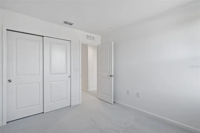 a view of an empty room and a window