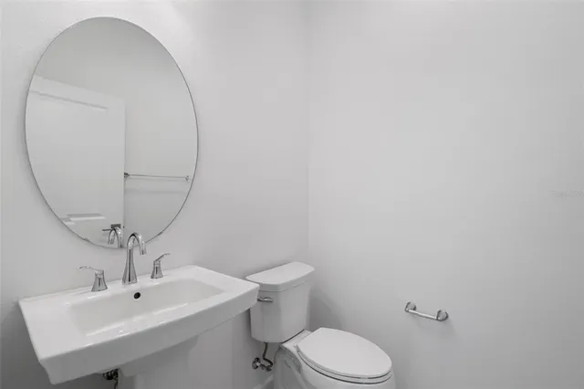 a kitchen with white cabinets sink and stainless steel appliances
