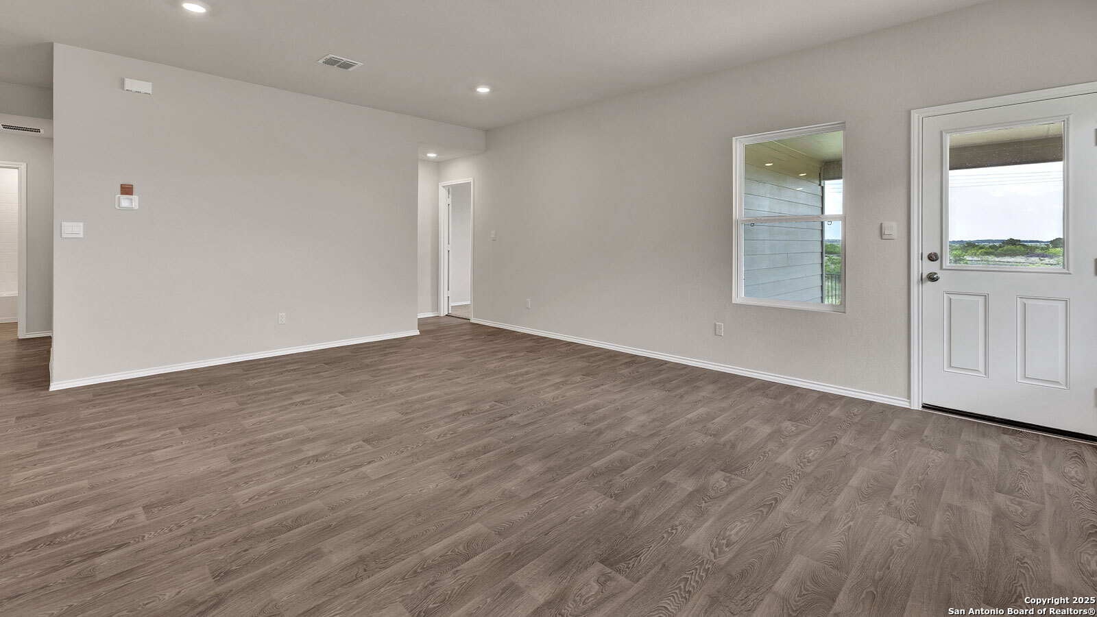 322 Hodges Street Maxwell, TX 78656 - Photo 20 of 34 a view of an empty room with wooden floor and a window