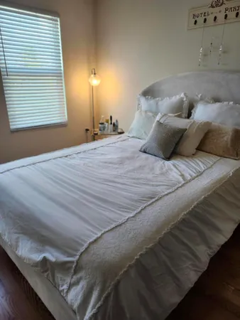 a bed sitting in a bedroom next to a window