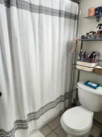 a white toilet sitting next to a small bathroom sink