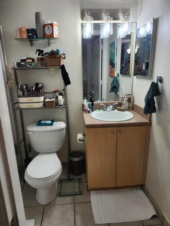 a bathroom with a toilet sink and mirror