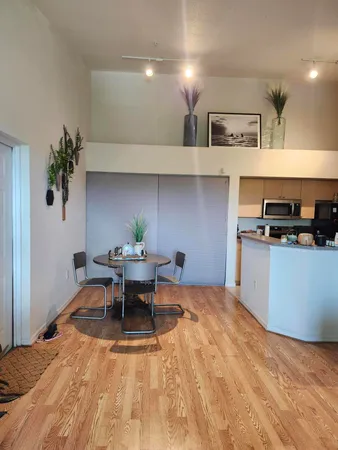a view of a kitchen with a dining table chairs and wooden floor