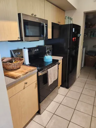 a kitchen with stainless steel appliances granite countertop a refrigerator stove and microwave