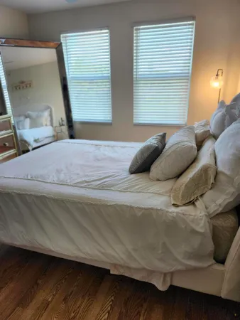 a bedroom with a bed and a mirror
