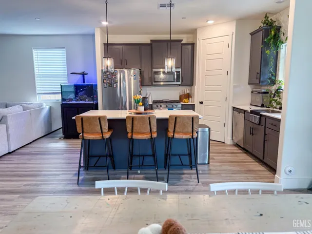 a large kitchen with a table and chairs