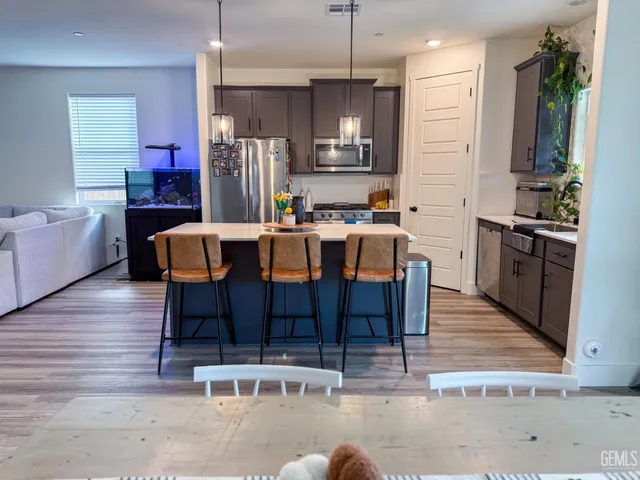 a large kitchen with a table and chairs