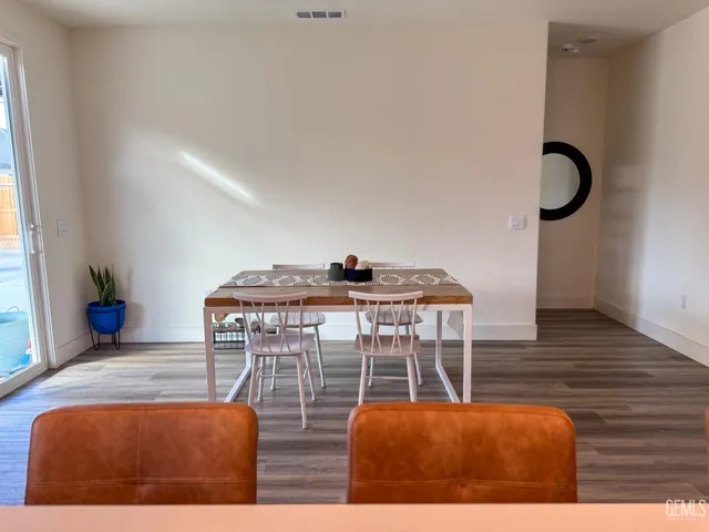 a dining room with furniture and wooden floor