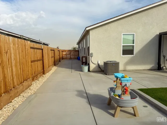 a view of a house with backyard porch and sitting area