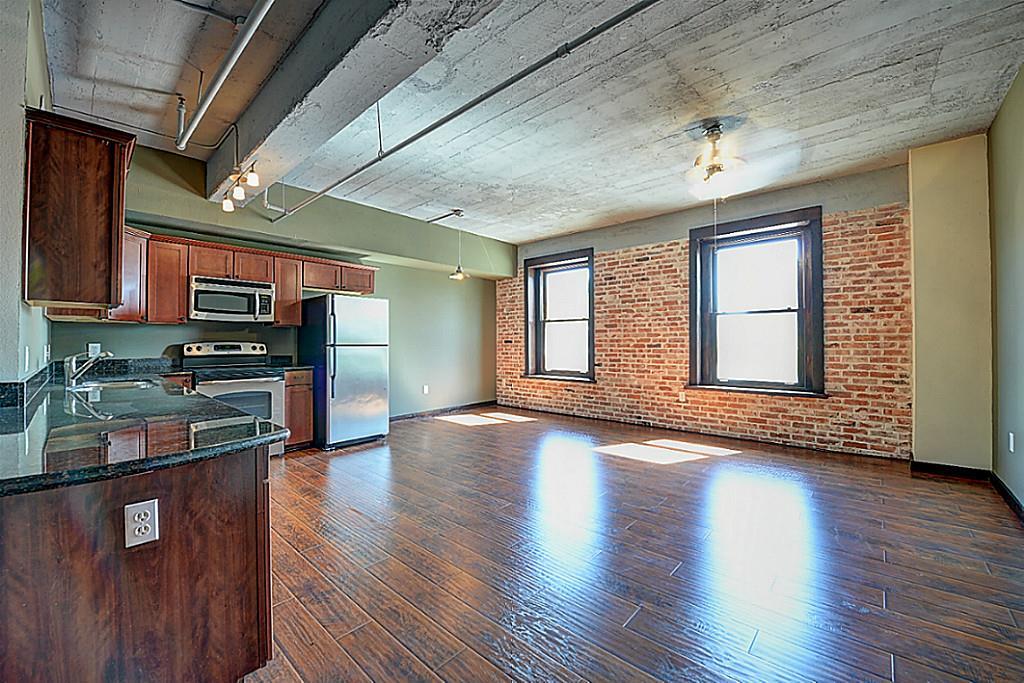 Welcome home to this spacious historic loft with exposed brick and wood laminate floors.
