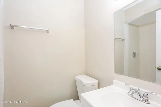 a white toilet sitting next to a bathroom sink