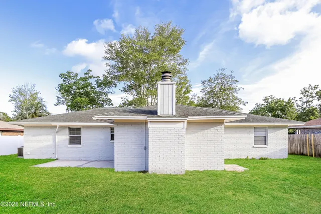 a front view of house with yard and trees