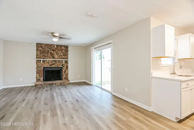 a view of a livingroom with a fireplace and wooden floor