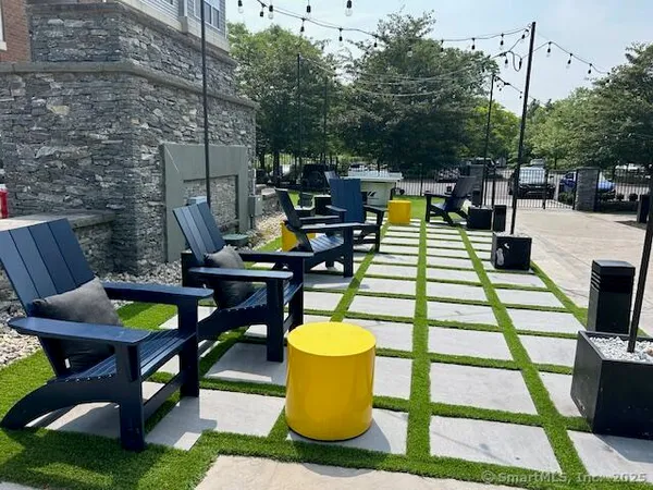 a view of a patio with table and chairs and potted plants