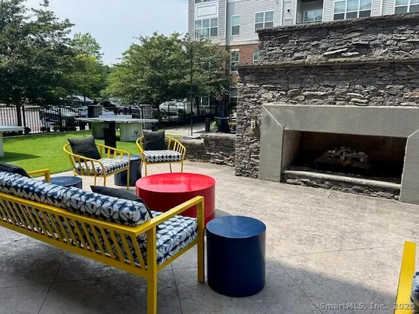 a outdoor living space with furniture and a fireplace