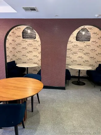 an empty room with a table and wall painting