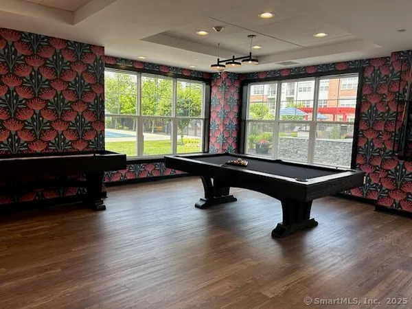 a room with pool table and windows