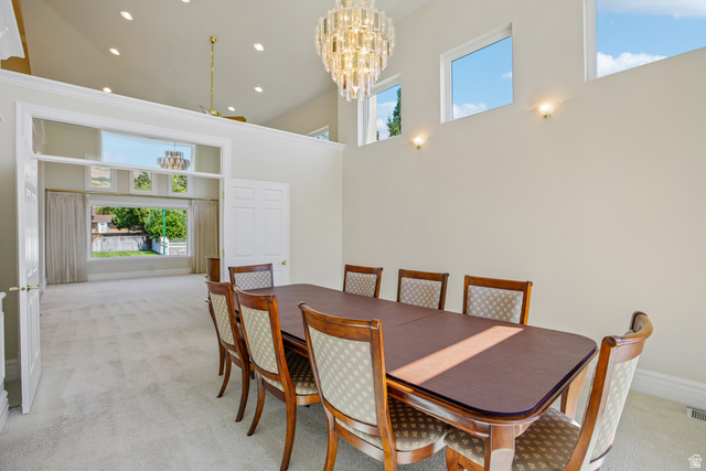 220 East Ridge Road Orem, UT 84057 - Photo 5 of 52 Vaulted ceiling with an ornate chandelier, multiple transom windows, recessed lighting, and an expansive doorway