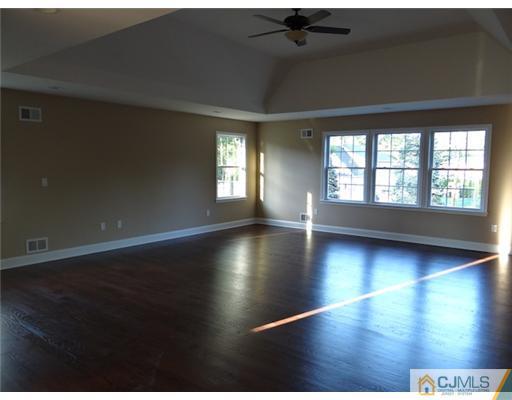 3 Tuscan Road Edison, NJ 08820 - Photo 14 of 17 an empty room with wooden floor and windows