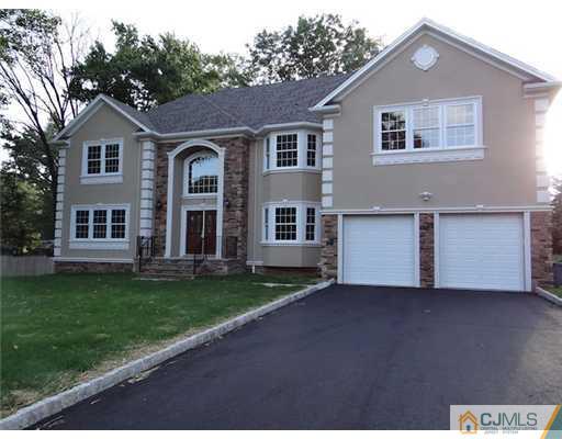 3 Tuscan Road Edison, NJ 08820 - Photo 3 of 17 a front view of a house with a garden