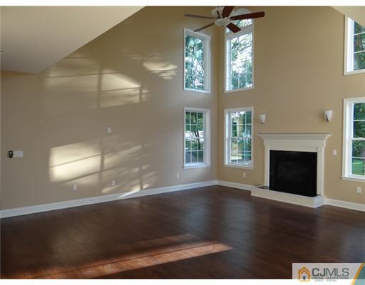 3 Tuscan Road Edison, NJ 08820 - Photo 8 of 17 a view of an empty room with wooden floor and a window