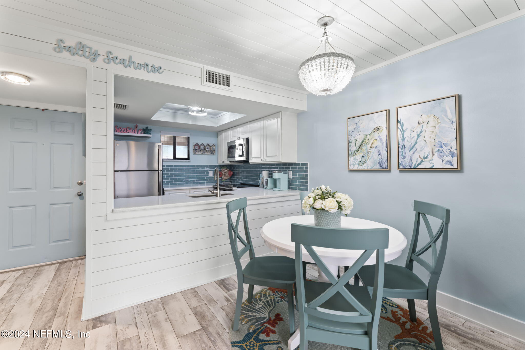4250 Florida A1A, Unit M35 St. Augustine, FL 32080 - Photo 13 of 57 a kitchen with stainless steel appliances kitchen island granite countertop a table chairs and a refrigerator