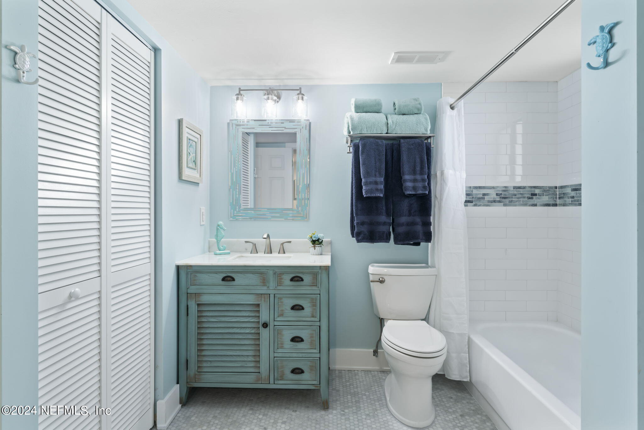 4250 Florida A1A, Unit M35 St. Augustine, FL 32080 - Photo 22 of 57 a bathroom with a toilet a sink a mirror a bathtub and vanity