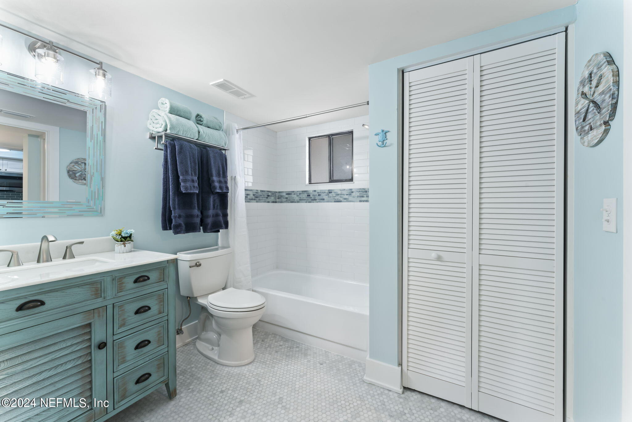 4250 Florida A1A, Unit M35 St. Augustine, FL 32080 - Photo 23 of 57 a bathroom with a toilet sink and mirror