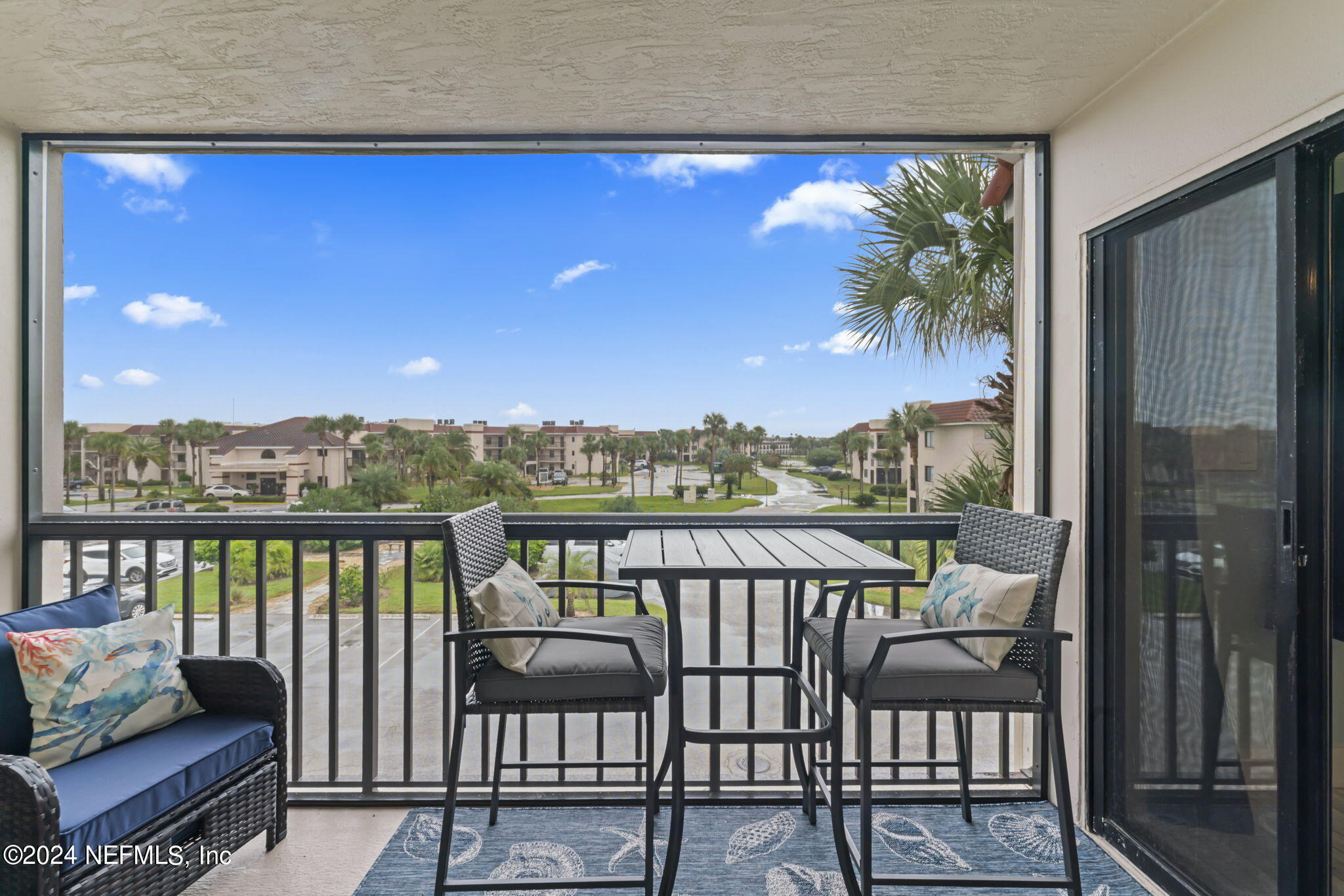 4250 Florida A1A, Unit M35 St. Augustine, FL 32080 - Photo 25 of 57 a view of a balcony with furniture and a floor to ceiling window